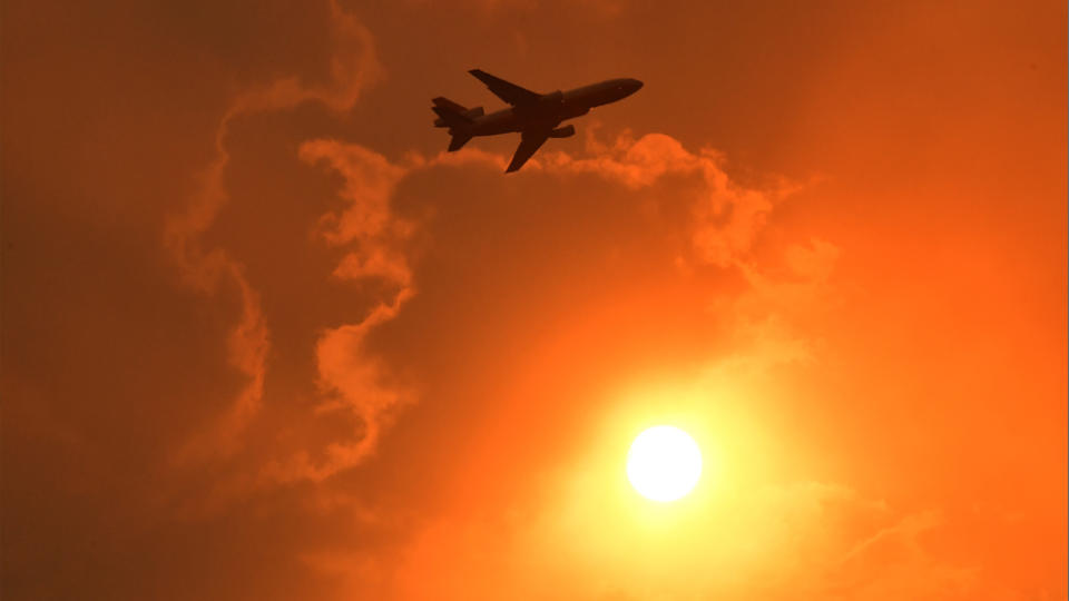 An Air Tanker makes a pass to drop fire retardant on a bushfire in North Nowra, 160km south of Sydney. Source: AAP  