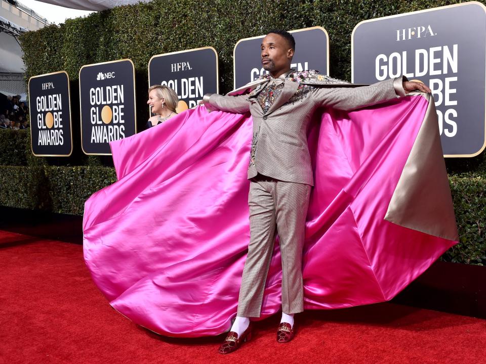 Billy Porter at the 2019 Golden Globes wearing a suit and pink cape