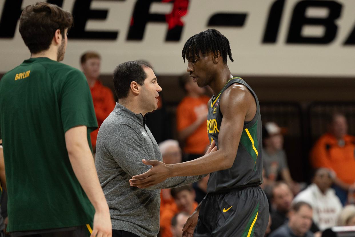 Baylor Bears head coach Scott Drew talks with guard Ja'Kobe Walter  in their Jan. 6 game in Stillwater with Oklahoma State. Walter is the Bears' leading scorer at 15.3 points per game.