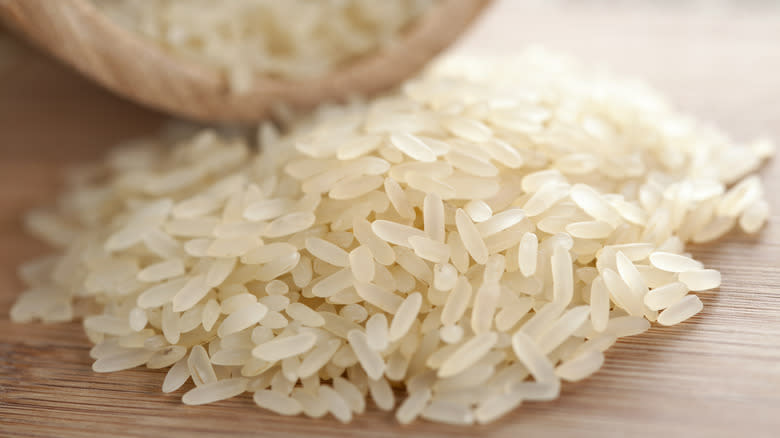 Dry rice grains on table