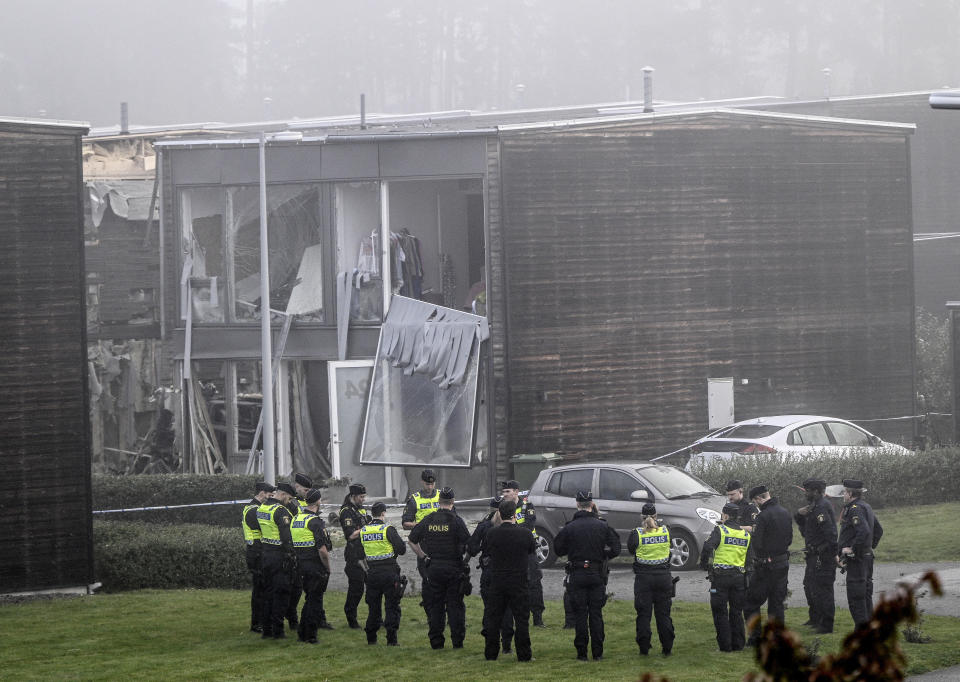 Police stand on the site of a powerful explosion that occurred early Thursday morning Sept. 28, 2023, in a housing area in Storvreta outside Uppsala, Sweden. A 25-year-old woman died in the blast. (Anders Wiklund/TT News Agency via AP)