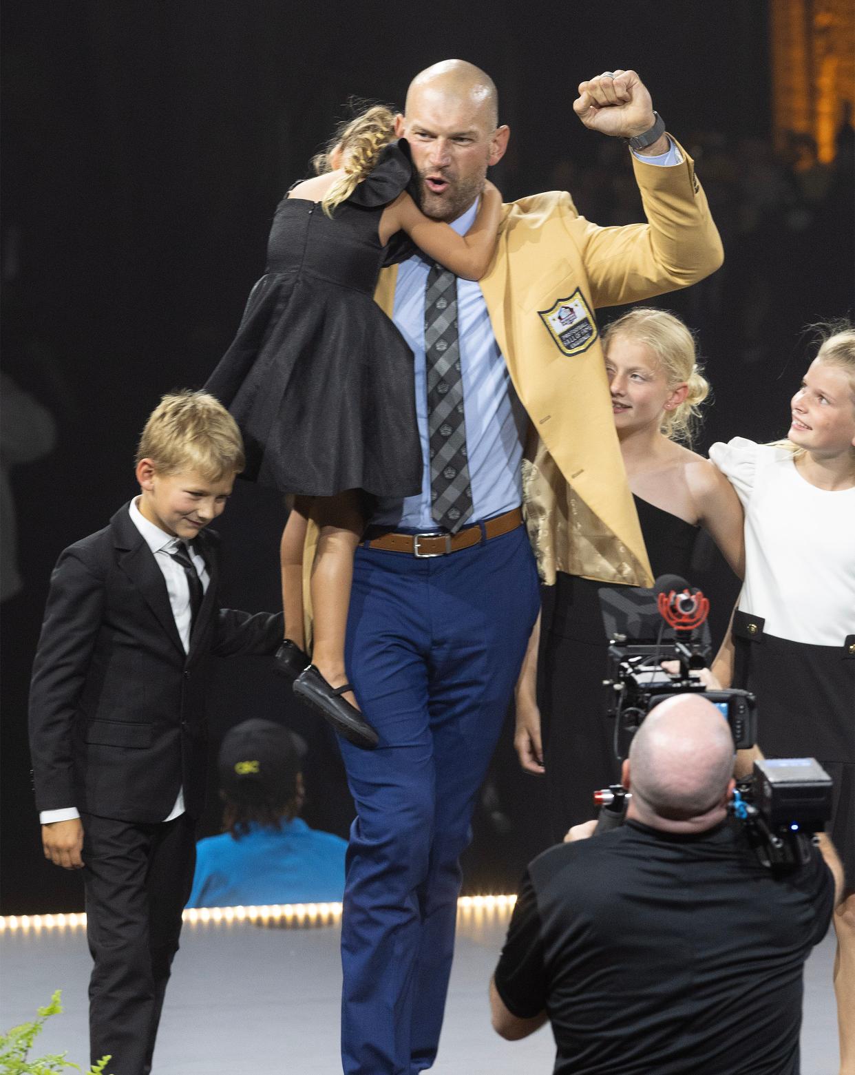 Joe Thomas celebrates with his children onstage at the 2023 Hall of Fame Enshrinees' Gold Jacket Dinner held at the Canton Civic Center. 