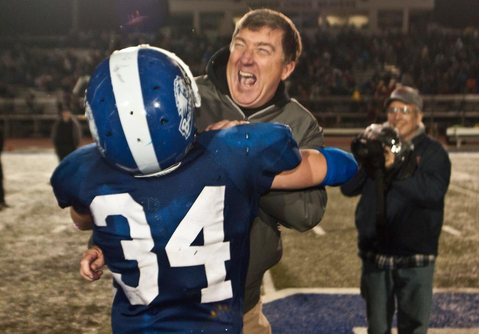 Harper Creek football coach Ed Greenman celebrates winning a regional title before the Beavers would go on to fall to Orchard Lake St. Mary's in the Division 3 state semifinals, 28-7.