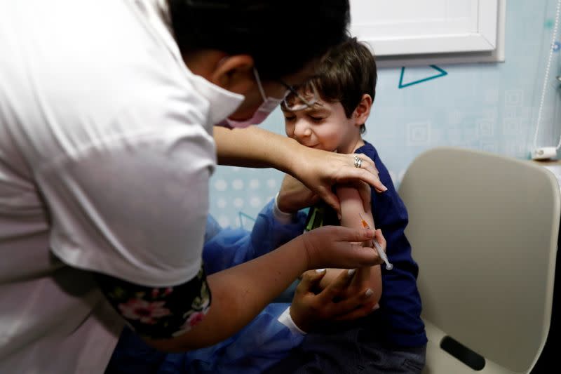 Itamar receives his first COVID-19 vaccination, after the country approved vaccinations for children aged 5-11, in Tel Aviv