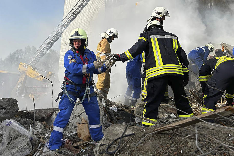 In this image provided by the State Emergency Service of Ukraine, firefighters work at an apartment building destroyed by a Russian attack in the town of Uman, around 215 kilometers (134 miles) south of Kyiv, Ukraine, Friday, April 28, 2023. (State Emergency Service of Ukraine via AP)