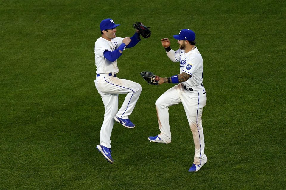 Kansas City Royals' Andrew Benintendi, left, and Kyle Isbel celebrate after the team's 14-10 win over the Texas Rangers in a baseball game Thursday, April 1, 2021, in Kansas City, Mo. (AP Photo/Charlie Riedel)