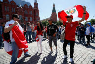 Supporters of the Peruvian national soccer team, a participant of the soccer World Cup, react during a gathering near the State Historical Museum and the Kremlin in central Moscow, Russia June 15, 2018. REUTERS/Gleb Garanich