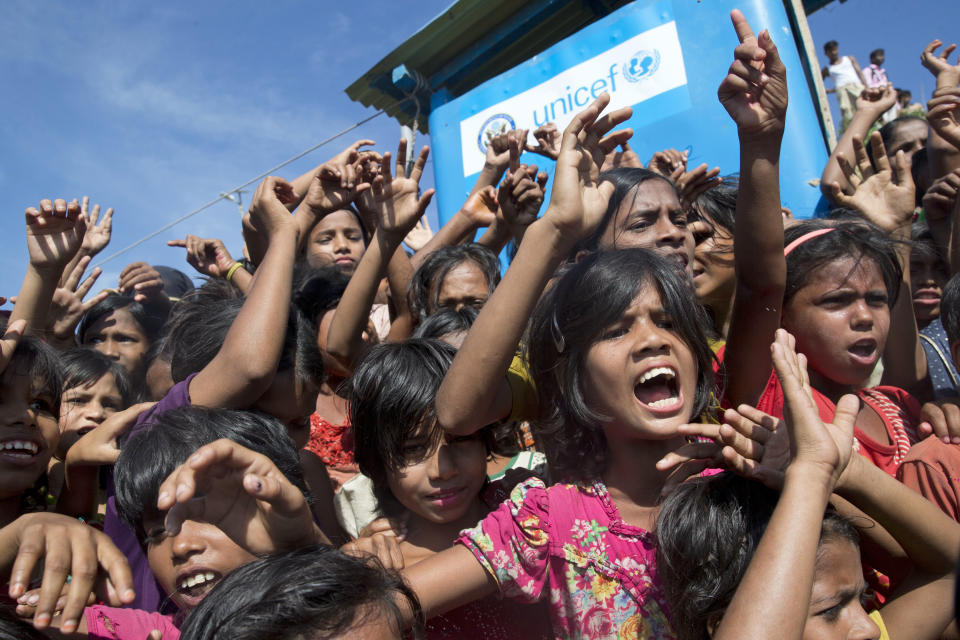 Rohingya refugee children shout slogans during a protest against the repatriation process at Unchiprang refugee camp near Cox's Bazar, in Bangladesh, Thursday, Nov. 15, 2018. The head of Bangladesh's refugee commission said plans to begin a voluntary repatriation of Rohingya Muslim refugees to their native Myanmar on Thursday were scrapped after officials were unable to find anyone who wanted to return. (AP Photo/Dar Yasin)