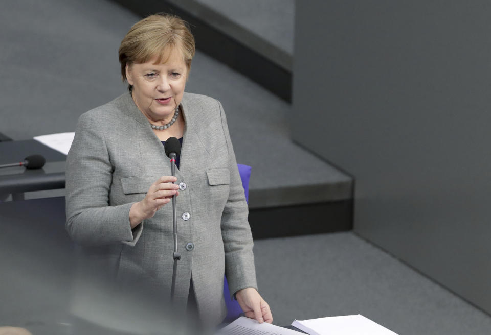 German Chancellor Angela Merkel takes questions as part of a meeting of the German parliament, Bundestag, at the Reichstag building in Berlin, Germany, Wednesday, Dec. 18, 2019. (AP Photo/Michael Sohn)