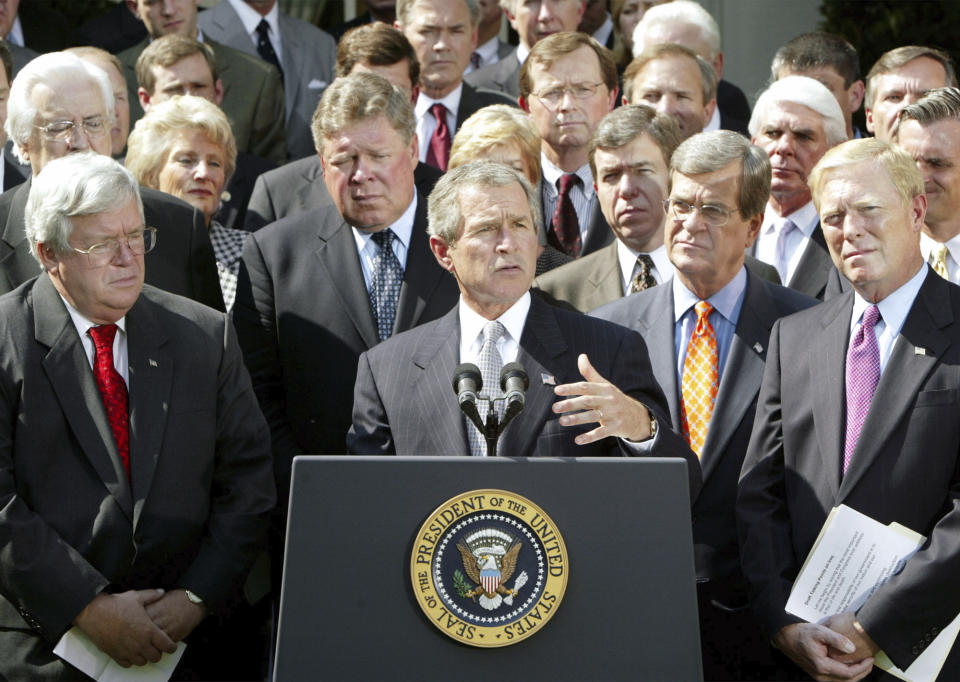 FILE - President George W. Bush announces he has reached an agreement with House leaders on a resolution giving him authority to oust Saddam Hussein, in the Rose Garden, Oct 2, 2002. Bush is joined by, from left to right front row, Speaker of the House Dennis Hastert, R-Ill, Bush, Sen. Trent Lott, R-Miss., and House Minority Leader Dick Gephardt, D-Mo. (AP Photo/Ron Edmonds, File)