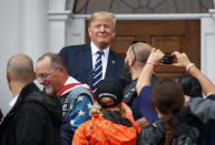 President Donald Trump visits with members of Bikers for Trump and supporters, Saturday, Aug. 11, 2018, outside the clubhouse of Trump National Golf Club in Bedminster, N.J. (AP Photo/Carolyn Kaster)