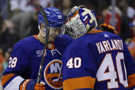 New York Islanders goaltender Semyon Varlamov celebrates with Alexander Romanov (28) after the team's 6-4 win over the New Jersey Devils in an NHL hockey game Friday, Dec. 9, 2022, in Newark, N.J. (AP Photo/Adam Hunger)