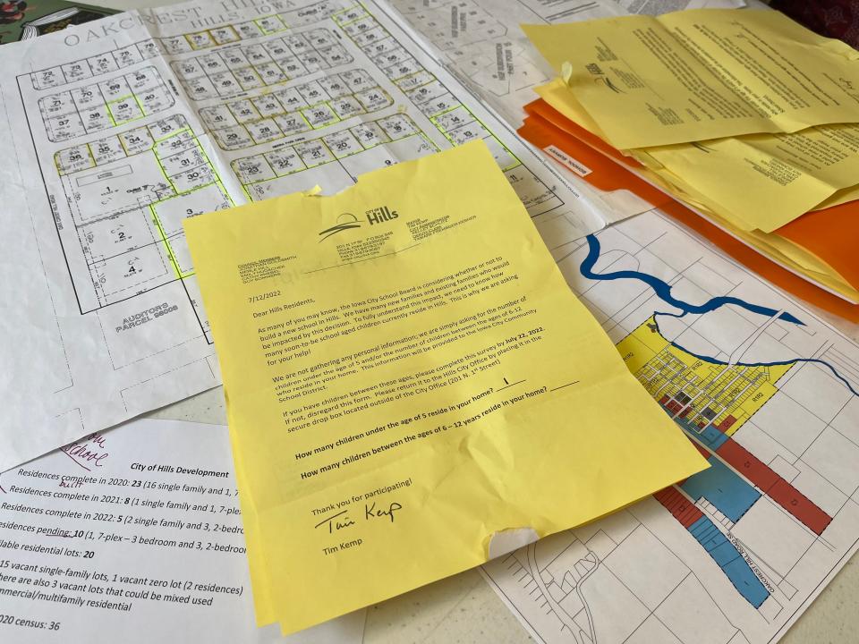 Staff from the City of Hills sent a survey to residents last week asking how many children ages zero through five and six through 12 live in the household. A returned survey and other materials related to the potential rebuilding of Hills Elementary sit on a table at the Hills city office on July 18, 2022.