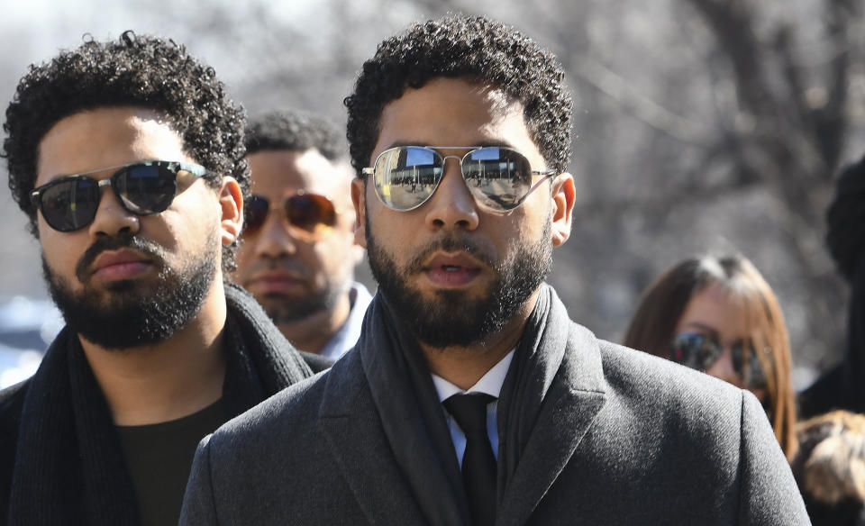 "Empire" actor Jussie Smollett, center, arrives at Leighton Criminal Court Building for a hearing to discuss whether cameras will be allowed in the courtroom during his disorderly conduct case on Tuesday, March 12, 2019, in Chicago. A grand jury indicted Smollett last week on 16 felony counts accusing him of lying to the police about being the victim of a racist and homophobic attack by two masked men in downtown Chicago.(AP Photo/Matt Marton)