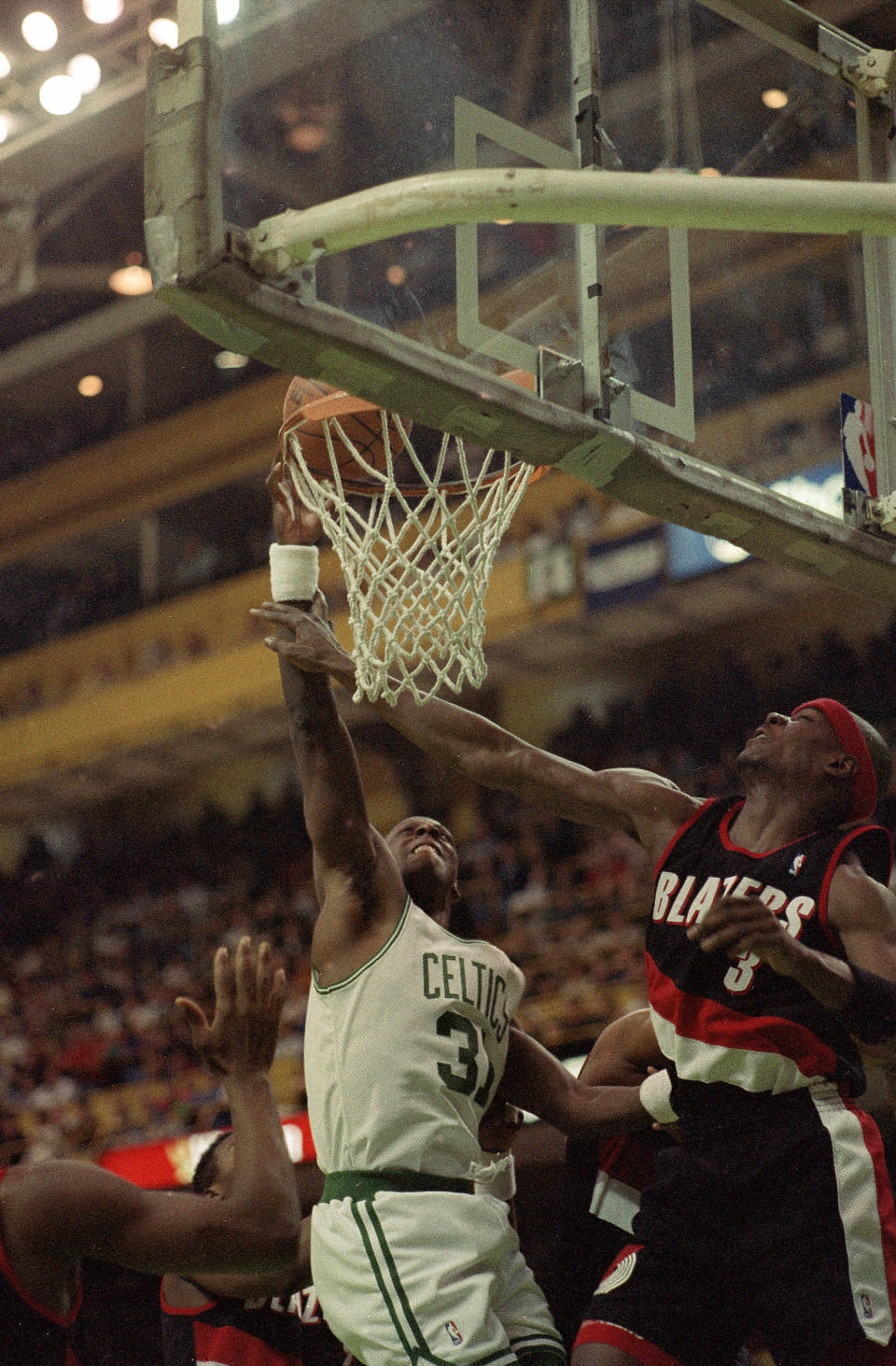 Boston Celtics forward Xavier McDaniel, left, also known as the “X-Man,” scores over Portland Trailblazers forward Cliff Robinson during the first half of their game at Boston Garden in Boston, Mass., March 1, 1993. McDaniel led the Celtics with 32 points as they beat Portland 122-110. AP Photo/Jon Chase