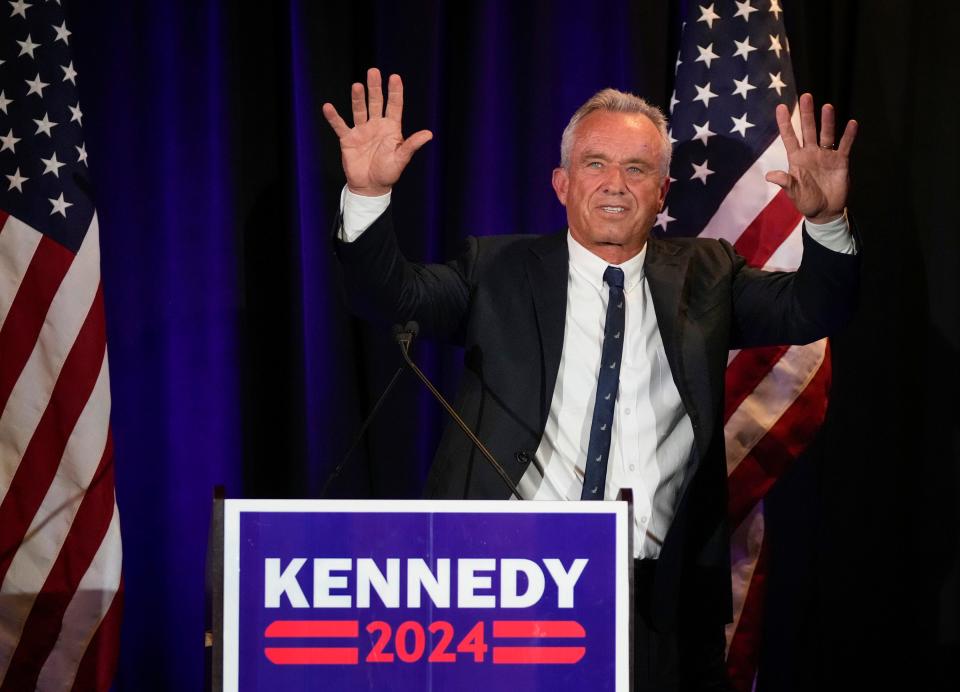 Independent presidential candidate Robert F. Kennedy Jr. waves to the crowd during a campaign rally Monday night at Brazos Hall in downtown Austin.