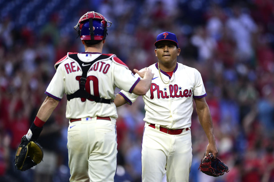 Philadelphia Phillies starting pitcher Ranger Suarez, right, is congratulated by J.T. Realmuto after their victory over the Pittsburgh Pirates, Saturday, Sept. 25, 2021, in Philadelphia. (AP Photo/Derik Hamilton)