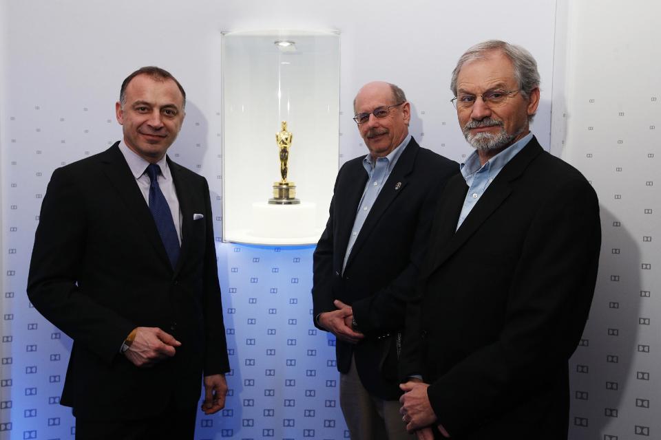 In this Monday, Feb. 11, 2013 photo, from left, Dolby's Ramzi Haidamus, vice president of marketing and business development, David Gray, vice president of content services, and Gary Epstein, product marketing manager of professional content tools pose for photos in the Dolby Lounge at the Dolby Theatre in the Hollywood section of Los Angeles. The 85th Academy Awards will be broadcast from the Dolby Theatre for the first time on Sunday, Feb. 24, 2013. (AP Photo/Jae C. Hong)