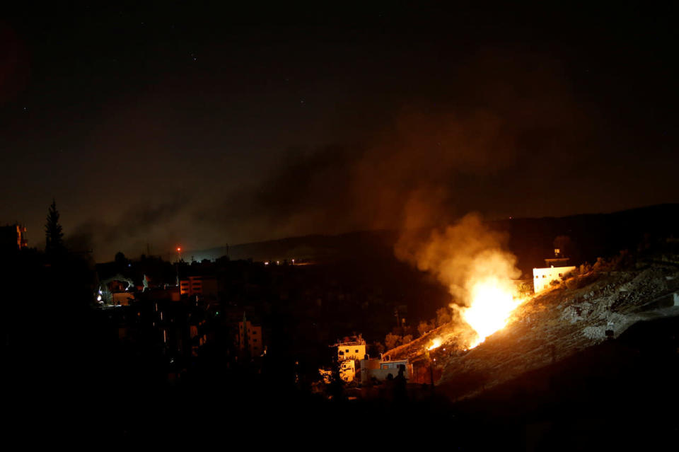 Flames are seen during a raid by Israeli forces on a house in West Bank