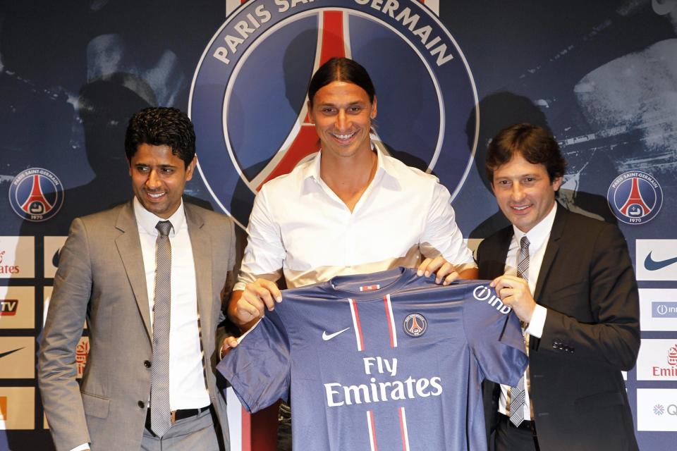 Ibrahimovic, newly-signed player for French soccer club Paris St Germain, holds his new jersey beside PSG President Al-Khelaifi and PSG sports director Leonardo after a news conference in Paris