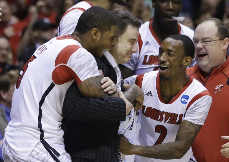 Russ Smith (2) celebrates advancing to the 2013 Final Four with his teammates and Rick Pitino. (AP)