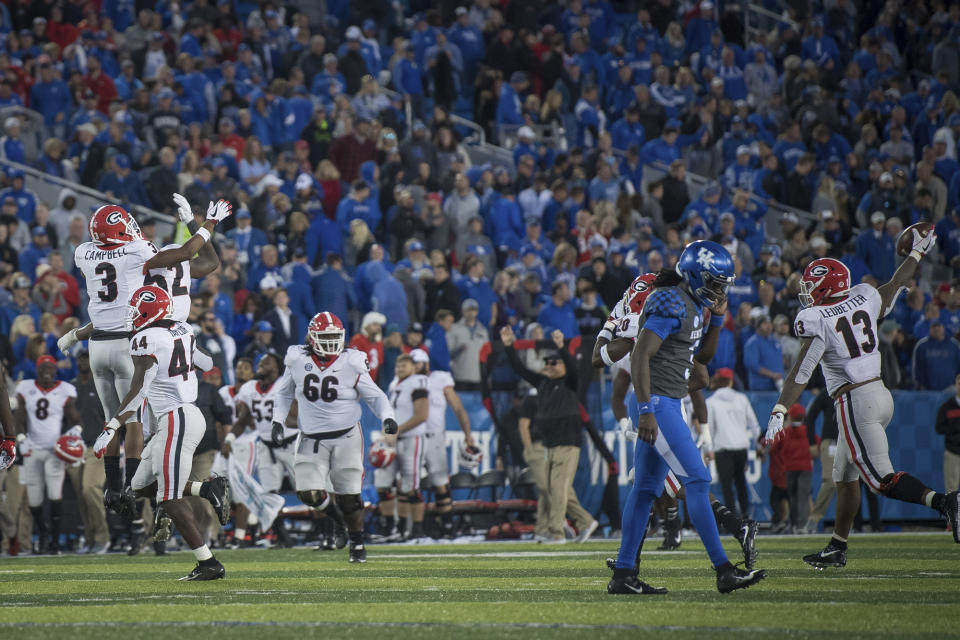 Georgia players celebrate victory after defeating Kentucky in an NCAA college football game in Lexington, Ky., Saturday, Nov. 3, 2018. (AP Photo/Bryan Woolston)