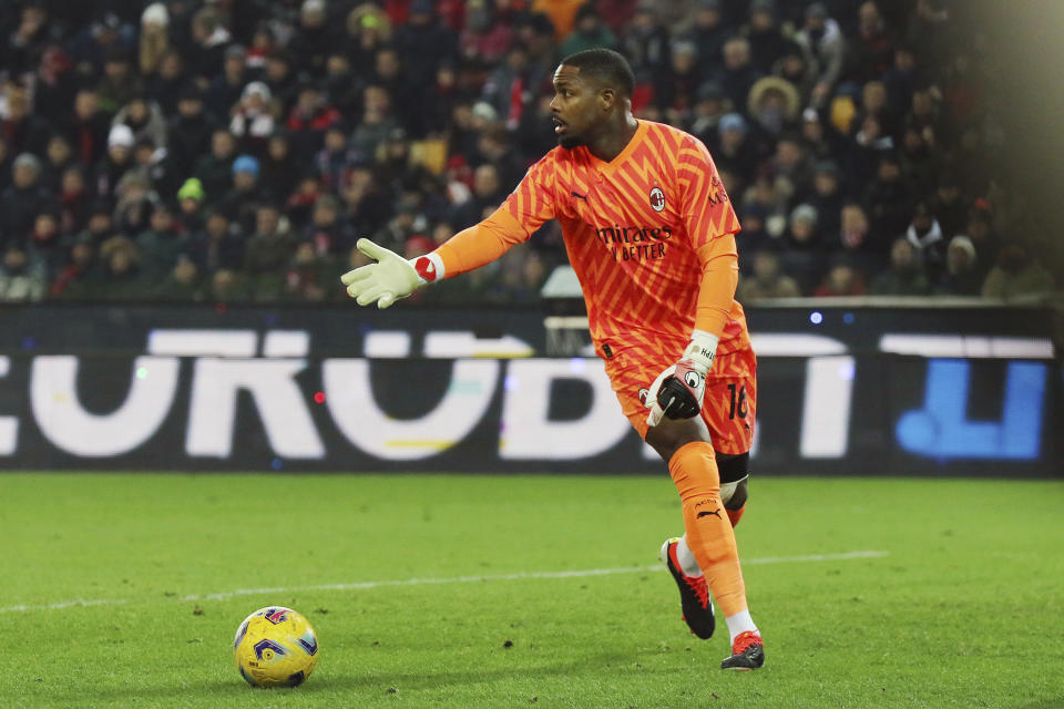 AC Milan 's goalkeeper Mike Maignan in action during the Italian Serie A soccer match between Udinese and AC Milan that was suspended, at the Friuli stadium in Udine, Italy, Saturday, Jan. 20, 2024. Racist abuse aimed at AC Milan goalkeeper Mike Maignan prompted a top-tier Italian league game at Udinese to be suspended briefly during the first half. Maignan left the field after the insults which followed a goal for Milan. (Andrea Bressanutti/LaPresse via AP)