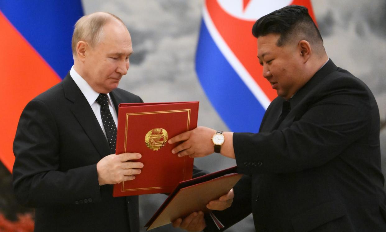 <span>Vladimir Putin and the North Korean leader, Kim Jong-un, exchange signed documents during a ceremony in Pyongyang on 19 June.</span><span>Photograph: Kristina Kormilitsyna/Sputnik/Kremlin pool/EPA</span>