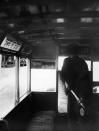 A man sprays the inside of a bus of the London General Omnibus Co with anti-flu preparation during the flu epidemic which followed the First World War, London, 2nd March 1920. (Photo by H. F. Davis/Topical Press Agency/Getty Images)