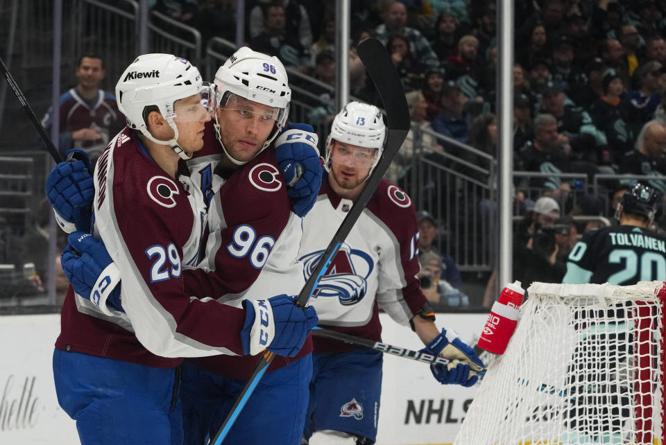 Colorado Avalanche right wing Mikko Rantanen (96) celebrates scoring against the Seattle Kraken with center Nathan MacKinnon (29) and right wing Valeri Nichushkin (13) during the second period of an NHL hockey game, Monday, Nov. 13, 2023, in Seattle. (AP Photo/Lindsey Wasson)