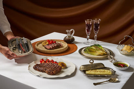 astor - steak and other dishes on table