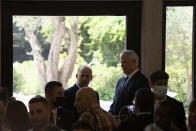 Israeli Prime Minister Naftali Bennett, rear left, speaks with Minister of Defense Benny Gantz, rear right, after they posed for a group photo with the ministers of the new government at the president's residence in Jerusalem, Monday, June 14, 2021. (AP Photo/Maya Alleruzzo)