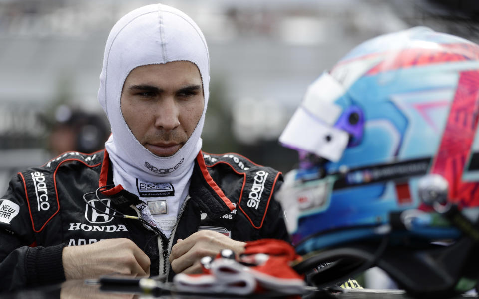 FILE - In this Aug. 18, 2018, file photo, Robert Wickens prepares to qualify for an IndyCar series auto race in Long Pond, Pa. Wickens is paralyzed from the waist down from injuries suffered in an August crash at Pocono Raceway. Wickens has been updating his rehabilitation progress on social media and posted a video Thursday of his "first slide transfer as a paraplegic" that showed him moving from a table to his wheelchair. His videos had shown for the past month that he is working daily to move his legs again, but his Thursday, Oct. 25, 2018, post was the first time he publicly confirmed paralysis. (AP Photo/Matt Slocum, File)