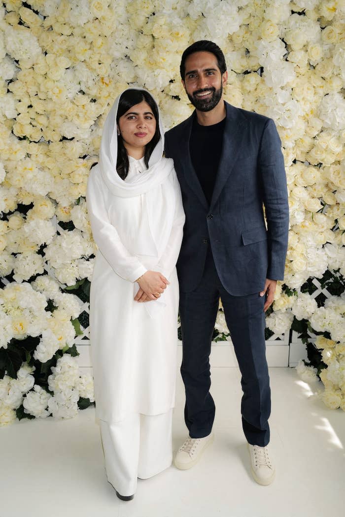 Malala and Asser against a floral backdrop