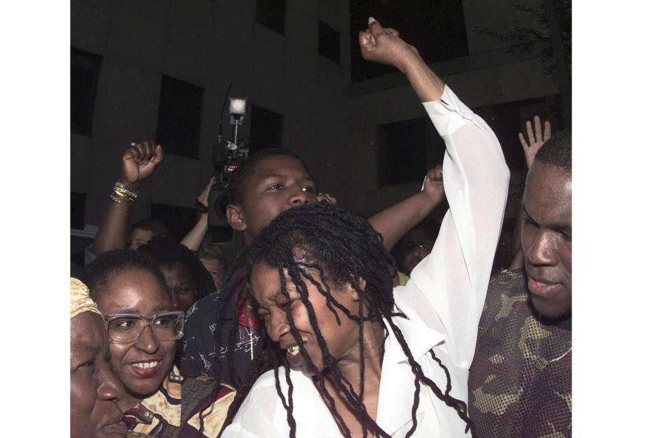 FILE - Betty Tyson raises her arm in celebration as she is released at the Public Safety Building, Wednesday, May 27, 1998, in Rochester, N.Y. Tyson, who spent 25 years in prison for murder before being exonerated will be laid to rest Friday. She was 75. (Shawn Dowd/Democrat and Chronicle via AP, File)