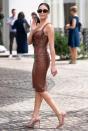 Olivia keeps things classic in her brown curve-hugging dress, printed shades and pointy-toe pumps while out in Cannes.