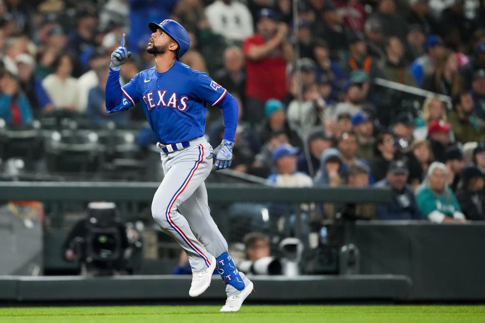 Texas Rangers' Leody Taveras gestures as he nears the plate on a home run against the Seattle Mariners during the third inning of a baseball game Thursday, Sept. 28, 2023, in Seattle. (AP Photo/Lindsey Wasson)