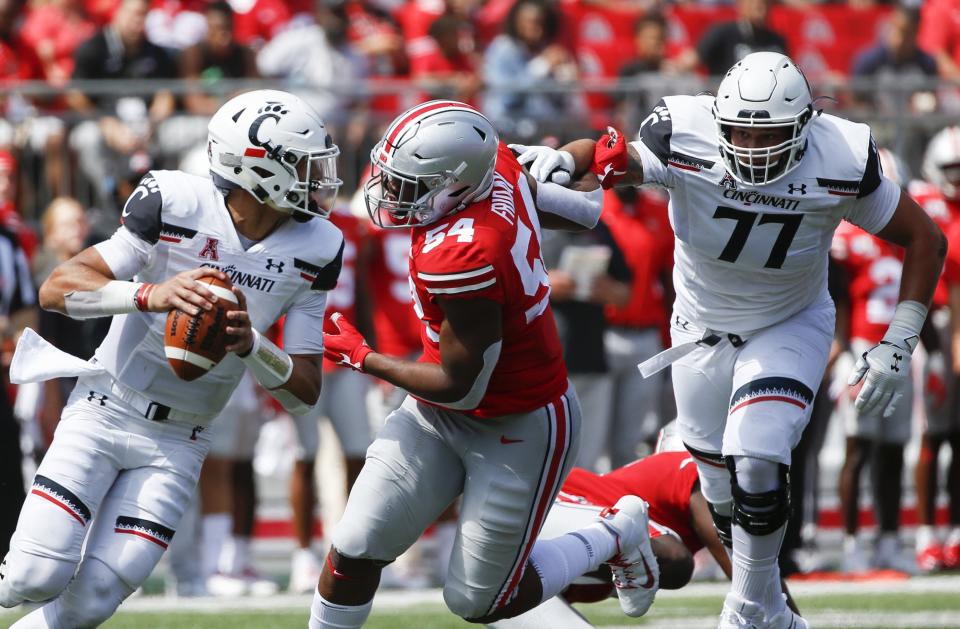 Ohio State Buckeyes defensive end Tyler Friday (54) tries to break free of Cincinnati Bearcats offensive lineman Vincent McConnell in a 2019 game at Ohio Stadium.