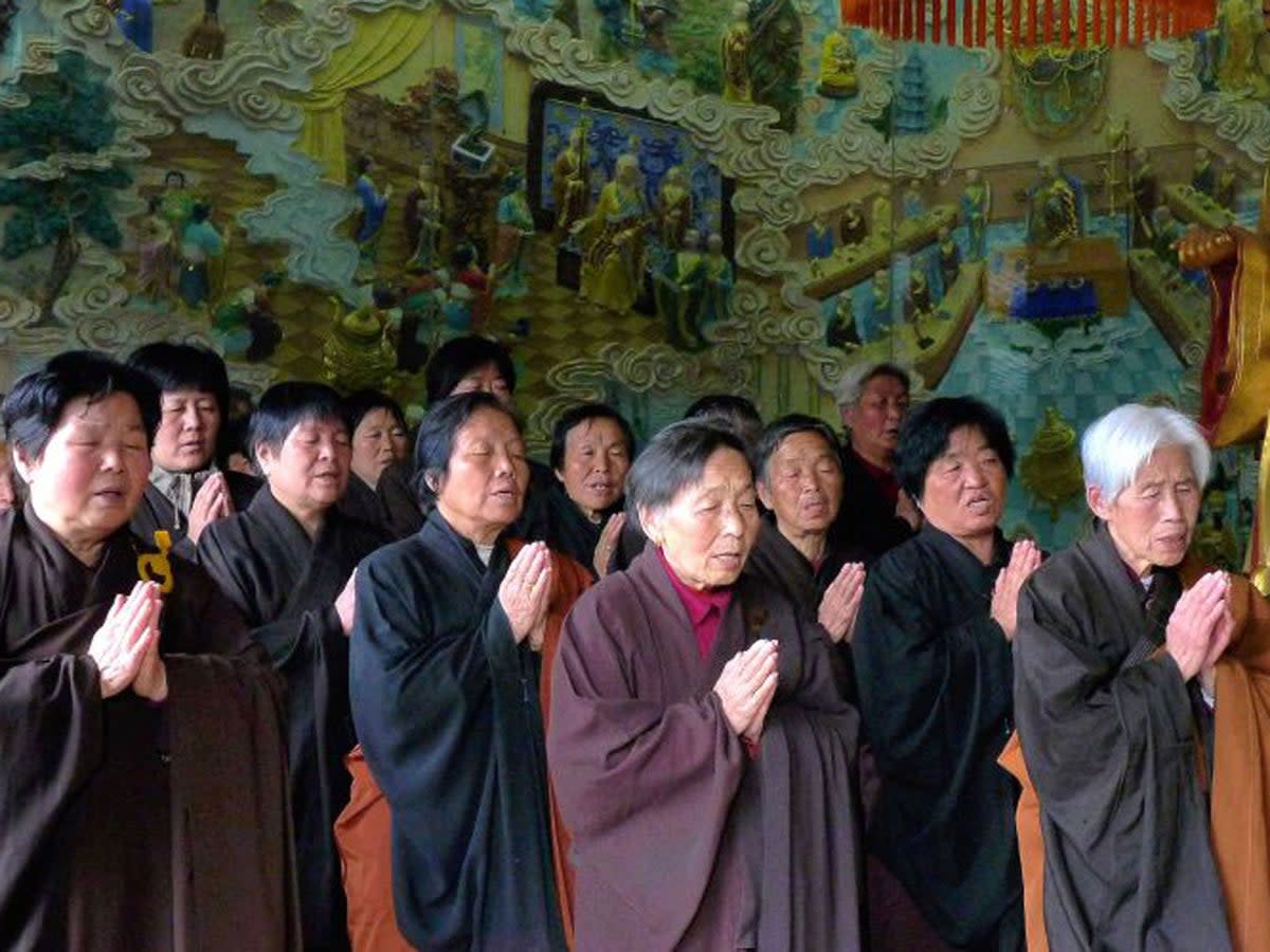Monks and Buddists singing scriptures (AFP)