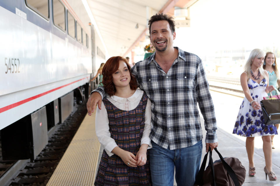 George and Tessa walking at a train station