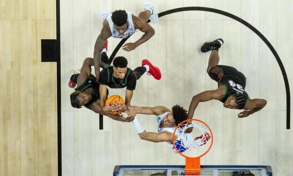 Kansas forward Jalen Wilson (10) fights for a rebound with Howard forwards Steve Settle III (2) and Shy Odom (22) during a first-round college basketball game in the NCAA Tournament Thursday, March 16, 2023, in Des Moines, Iowa.