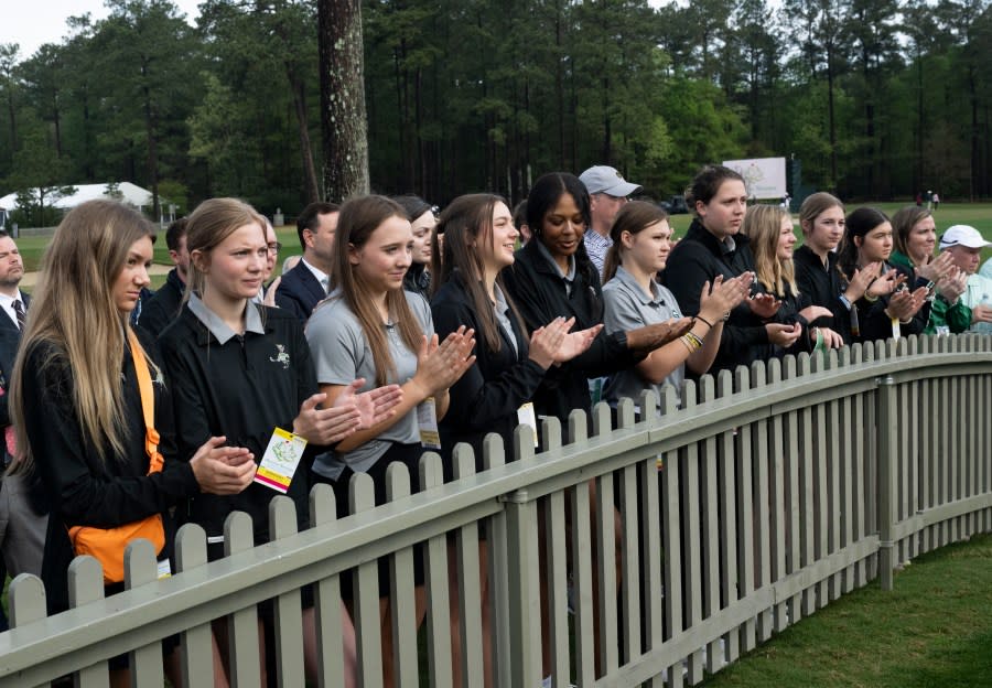 Members of the Greenbrier High School Girls Golf Team watch the opening tee stroke on the No. 1 tee during round one of the Augusta National Women’s Amateur at Champions Retreat Golf Club, Wednesday, April 3, 2024.