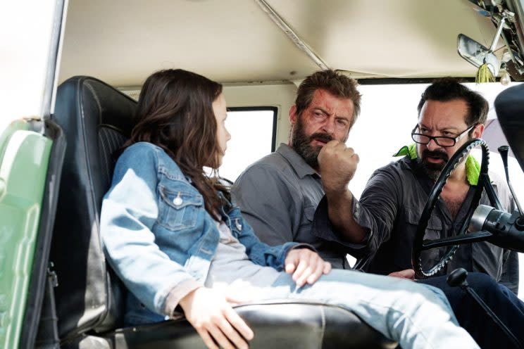 Dafne Keen and Hugh Jackman take direction from James Mangold on the set of “Logan.” (Photo: 20th Century Fox)
