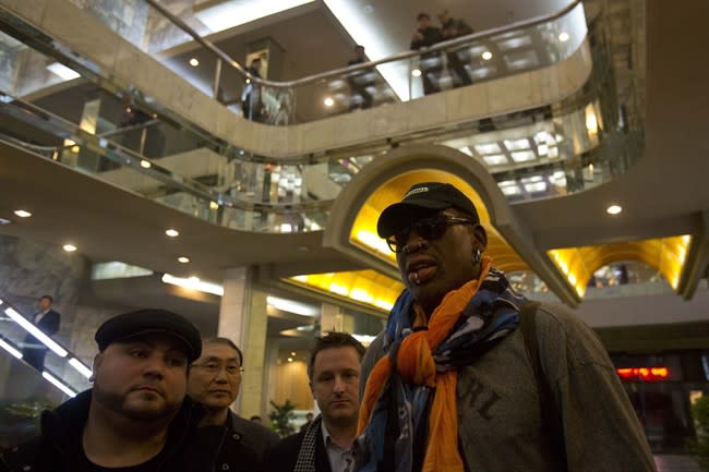 North Koreans look down from a balcony as former NBA basketball star Dennis Rodman enters the Koryo Hotel in Pyongyang, North Korea Thursday, Dec. 19, 2013. Rodman arrived to the North Korean capital to help train the national team and renew his friendship with the North's young leader, Kim Jong Un. (AP Photo/David Guttenfelder)