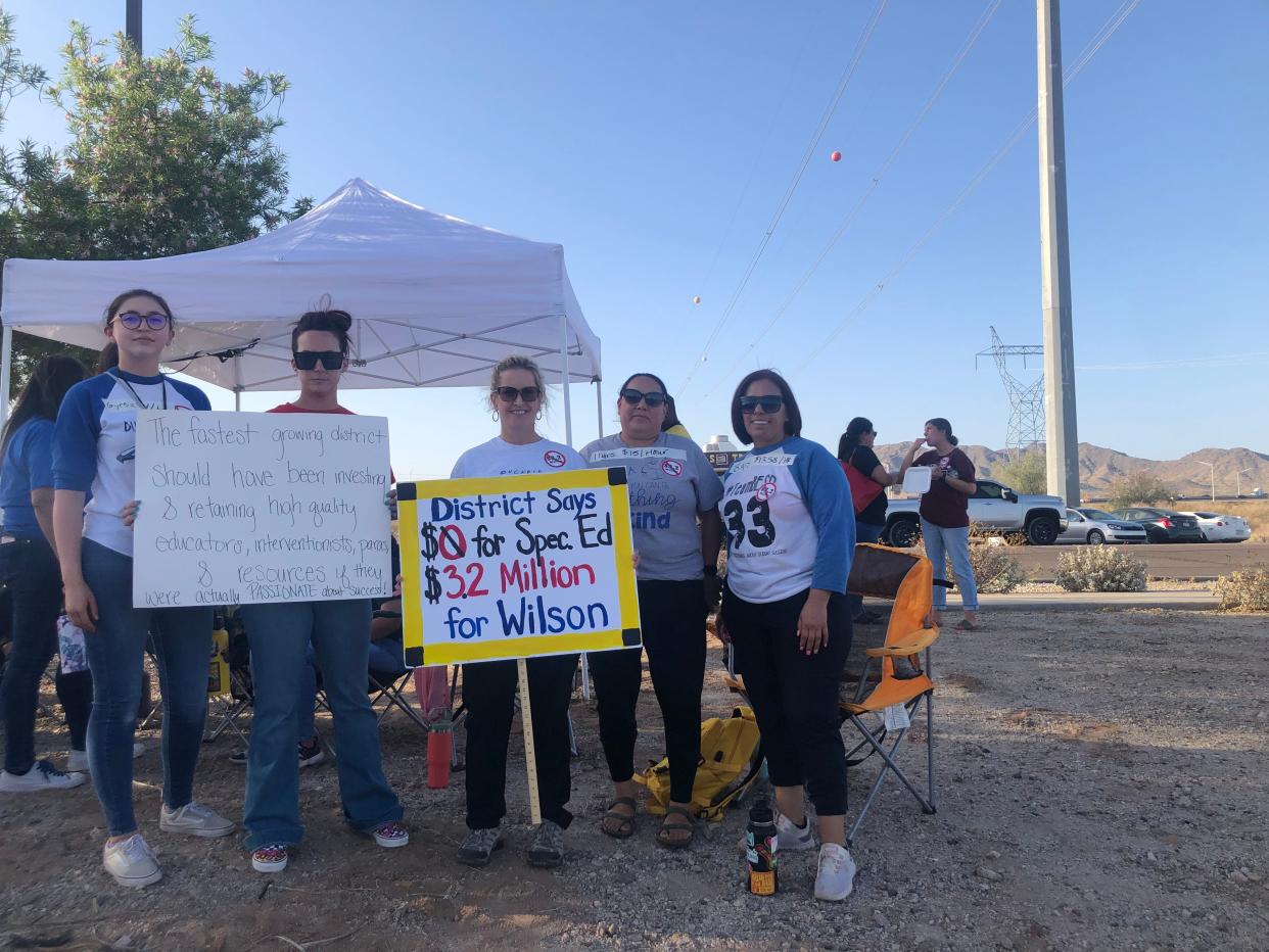 A group of educators stands together before the Buckeye Elementary School District meeting on May 2, 2022.