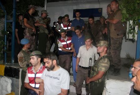 Turkish gendarmeries escort fugitive commandos who were involved in a bid to seize President Tayyip Erdogan during a failed coup attempt last month, as they leave from a gendarmerie station in Mugla province, Turkey, early August 1, 2016. REUTERS/Kenan Gurbuz