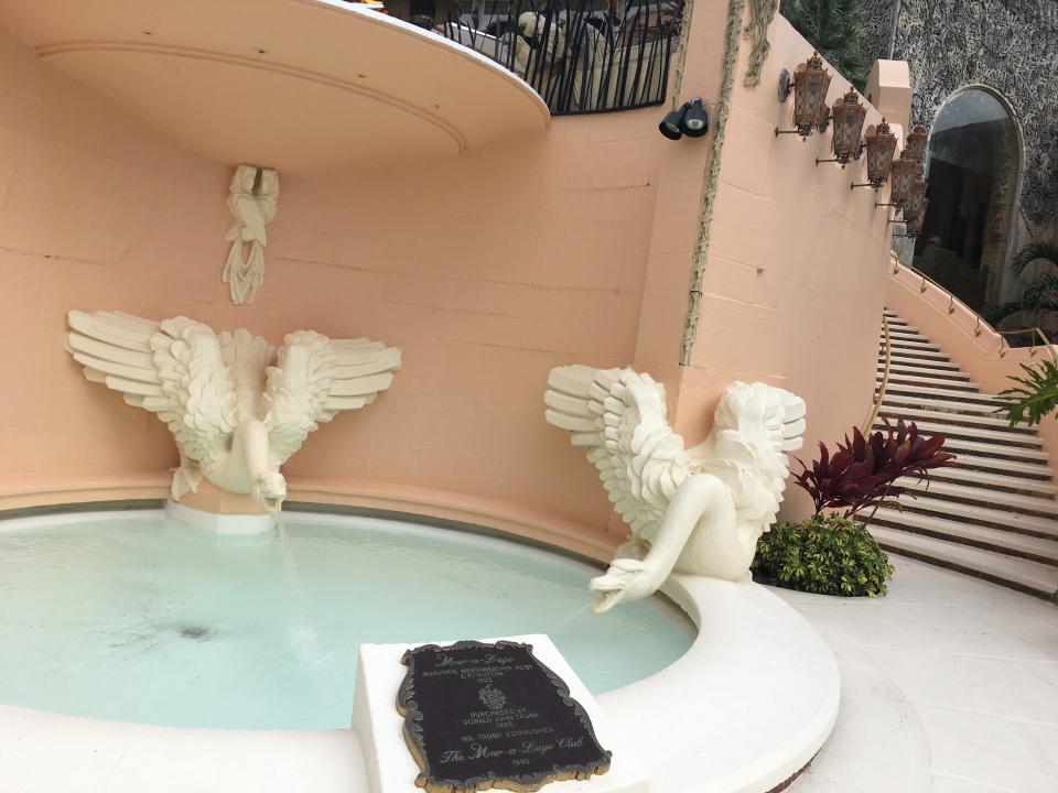 A fountain at Mar-a-Lago with a plaque that says Trump purchased the club in 1985.