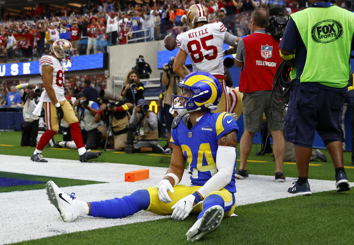 Taylor Rapp of the Los Angeles Rams reacts as Christian McCaffrey of the San Francisco 49ers celebrates a touchdown. (Photo by Ronald Martinez/Getty Images)