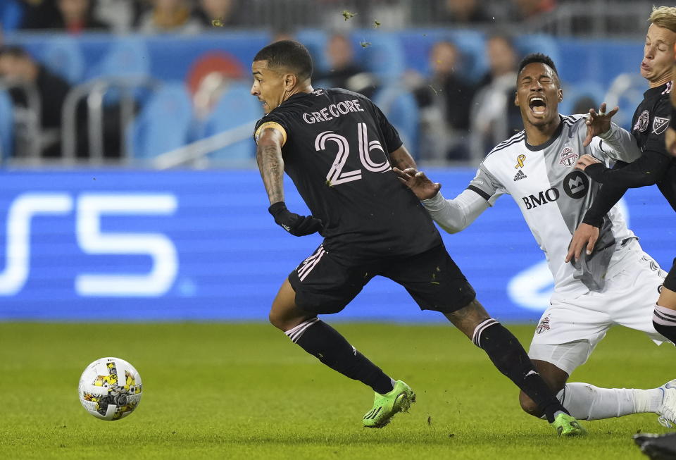 Inter Miami midfielder Gregore (26) trips Toronto FC midfielder Ralph Priso during the first half of an MLS soccer match Friday, Sept. 30, 2022 in Toronto. (Nathan Denette/The Canadian Press via AP)