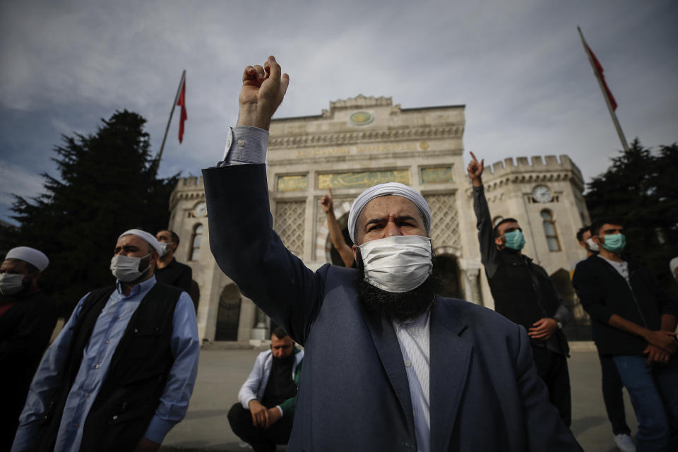 Demonstrators chant slogans during an anti-France protest in Istanbul, Sunday, Oct. 25, 2020. Turkish President Recep Tayyip Erdogan on Sunday challenged the United States to impose sanctions against his country while also launching a second attack on French President Emmanuel Macron. Speaking a day after he suggested Macron needed mental health treatment because of his attitude to Islam and Muslims, which prompted France to recall its ambassador to Ankara, Erdogan took aim at foreign critics. (AP Photo/Emrah Gurel)